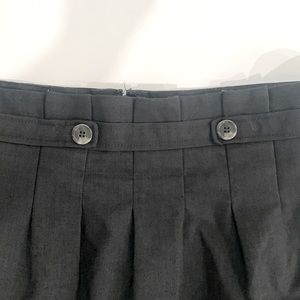 Ann Taylor Charcoal grey pleated skirt with side pockets.